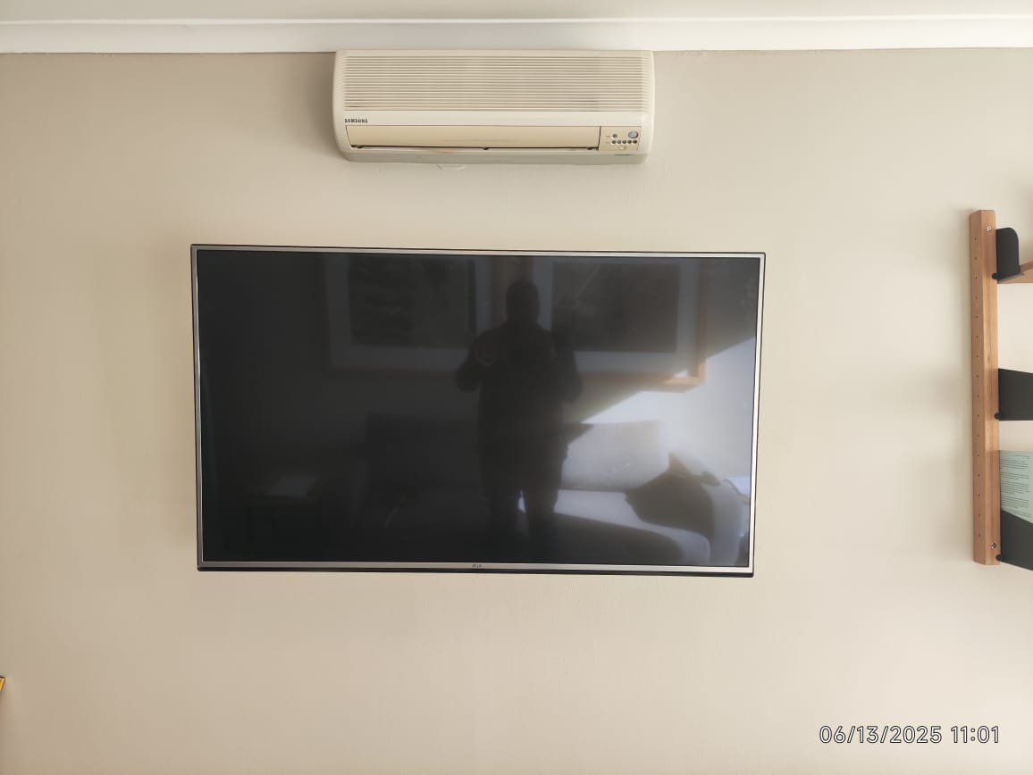 Wall-mounted television installed level in a Cape Town home